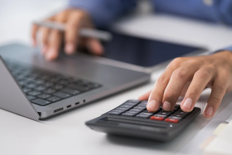 Expat using laptop and calculator to file US taxes from Thailand