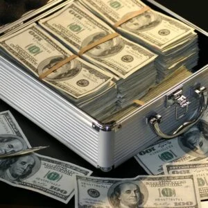 Stacked dollar bills representing the $120,000 FEIE threshold for US expats