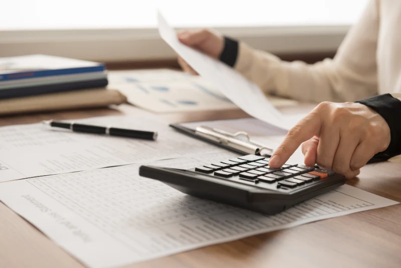 Tax documents and calculator on desk for FEIE vs Foreign Tax Credit analysis