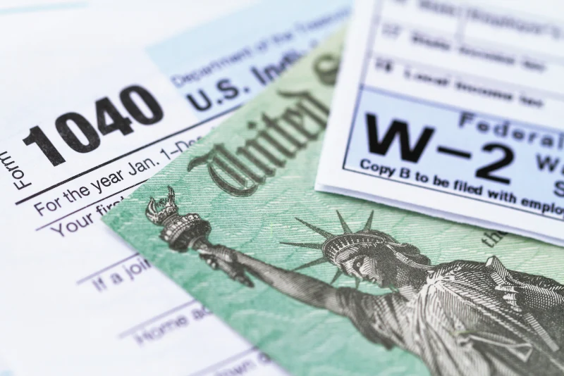 IRS Form 1040 and currency documents for US expats filing taxes from Thailand